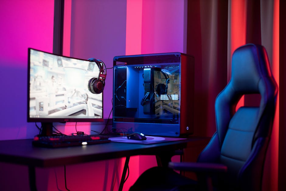 A sleek gaming setup featuring a high-end PC, widescreen monitor, and ergonomic chair lit by neon lights.